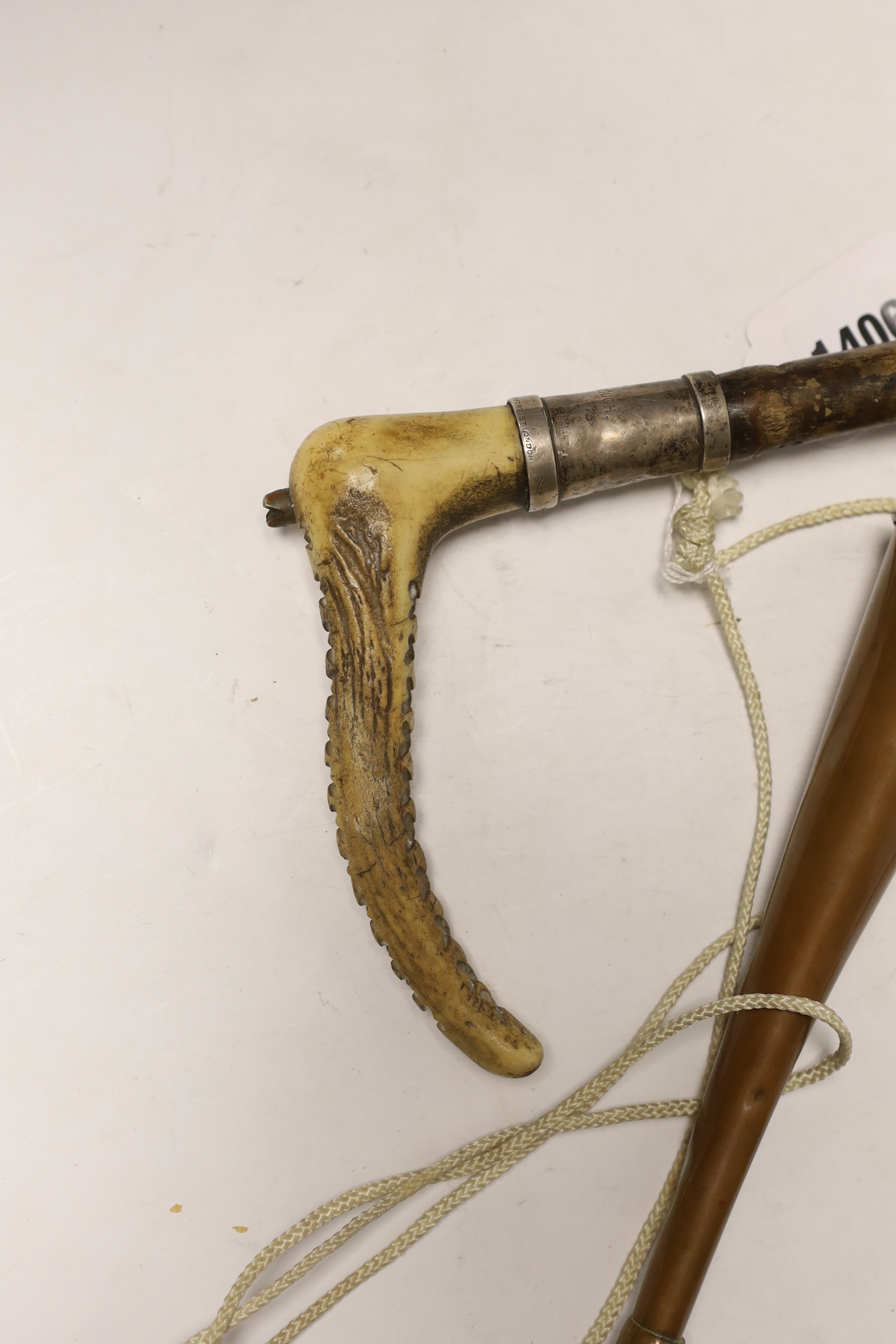 A silver mounted riding crop, a hunting horn and a horn whistle